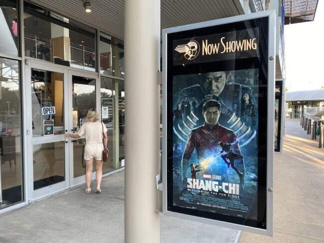 A Shang-Chi movie poster in front of the Angelika box-office in Dallas.