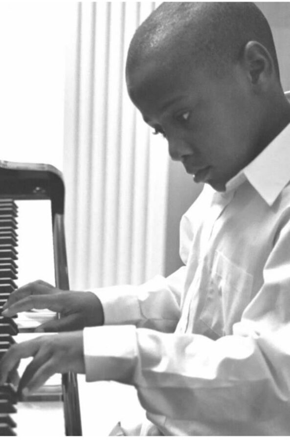 Young Warren Jr. plays piano.
