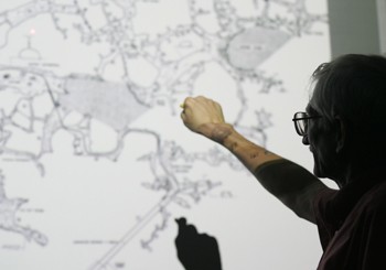 SMU alum Pete Lindsley explains one of his caving maps during his presentation Wednesday for the Outdoor Adventure Program.