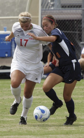 Photo by John Schreiber, The Daily Campus; Photo by John Schreiber, The Daily Campus; Mustang sophomore Caitlin Carter takes the ball from UTSAs Chelsea Zimmerman at Westcott Field on last Saturday.
