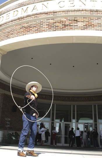Kalvin Cook, a world champion roper from Oklahoma, demonstrates roping tricks outside the Dedman Center for Lifetime Sport during yesterdays official dedication ceremony.  Cook is also in the Guiness Book of World Records for twirling the worlds biggest rope loop.
