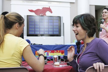 Evangeline Airth (right) reacts after beating Andrea Rowland (left) in a game of Hughes-Trigg Jeoprady during the student centers 19th birthday party.