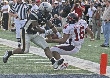 Rice's Chad Price (left) tries to grab the ball from SMU's Justin Willis (right) during Saturday's game in Houston.