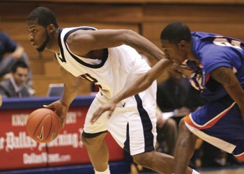 SMUs Devon Pearson (left) pushes past Houston Baptists Stephen Floyd (right) during Saturday nights exhibition game.