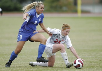 SMUs Katie Leonard (right) and Tulsas Emily McElrath (left) struggle for the ball during the first game of the C-USA conference tournament at Westcott Field.