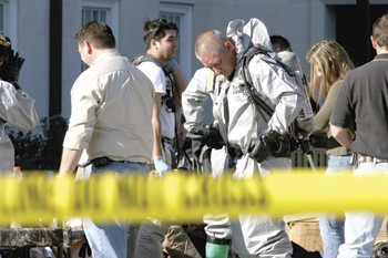 Members of the Garland Health Department Mobile Lab prepare to enter the Laura Lee Blanton Building Friday afternoon. The Blanton building was evacuated after an employee in the mailroom fell ill after opening an envelope which turned out to be filled with a cooking spice.