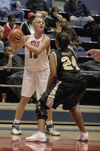 SMU's Leah Starr (left) looks for an open teammate while UCF's Randall Hurst (right) blocks.