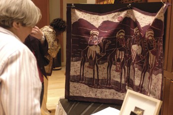 Visitors look at an art piece part of the "Art for Darfur" exhibit held Thursday in the Meadows School of the Arts.