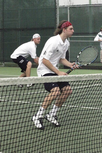 SMUs Robin Faghen protects the net during a doubles match with partner Oivind Alver.