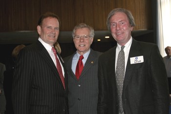 Jim Caswell, center, pauses for a photo Wednesday at a reception honoring his tenure at SMU. He is retiring at the end of May.