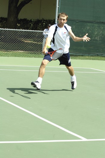 SMUs David Kuczer returns the ball during the match against UIC at Bent Tree Tennis Center.