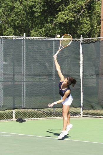 SMUs Kristin Reid serves the ball during the match against ULL at Garland Tennis Center on Saturday.