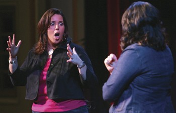 Becky Tieder (left) shows fellow speaker Kelly Addington (right) the reaction of her friend when she told him she was sexually assaulted.  Tieder and Addington spoke about sexual assault during the Lets Talk About It presentation last night in McFarlin Auditorium. 