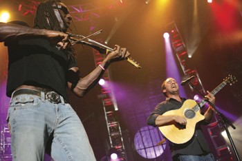 Dave Matthews Band violinist Boyd Tinsley performs next to the bands namesake on Saturday night at the Smirnoff Music Center at Fair Park. 