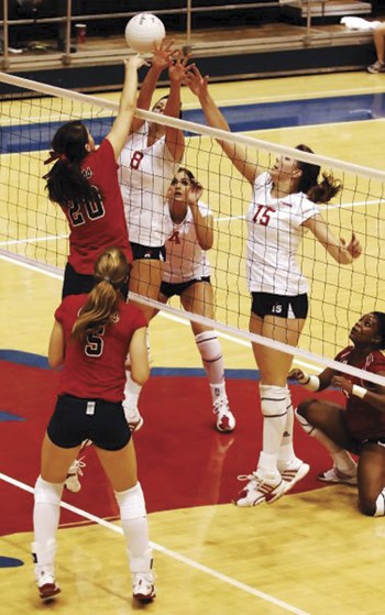 Ole Miss Lauren Moffett (No. 20) spikes the ball past SMUs Caitlin Rainbird (No. 8) and Kathryn Wilkerson (No. 15) during Friday nights game at Moody.