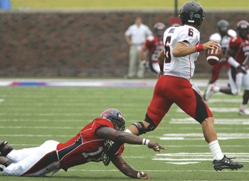 Texas Tech quarterback Graham Harrell evades a tackle from SMUs Cory Muse. Harrell was able to evade the Mustangs defense all afternoon as he threw for 419 yards and four touchdowns.