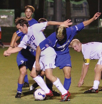 SMU midfielder Jeff Harwell (3) tries to break through a host of Memphis defenders during Saturday nights game at Westcott Field. Photo by Nick McCarthy, The Daily Campus