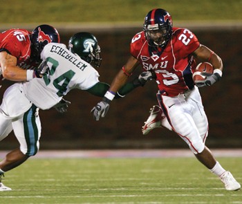 SMU runningback Cedrick Dorsey (right) tries to get past Tulane safety Chinonso Echebelem (left) during Saturday nights game.
