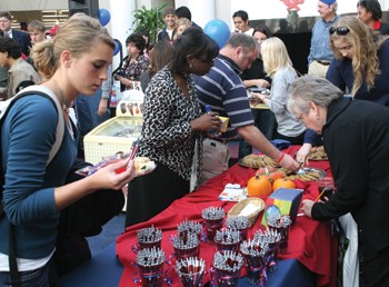 Students, staff and faculty enjoy treats in the second floor commons during the Hughes-Trigg 20th Birthday celebration. 