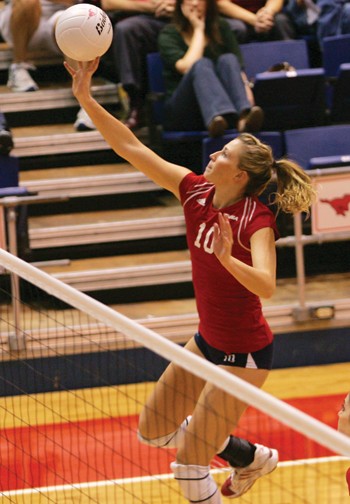 SMUs Natalie Peters taps the ball over the net.
