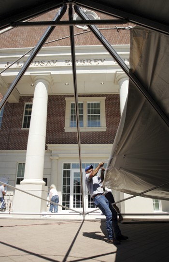 Workers set up a party tent outside of the J. Lindsay Embrey Building at last years dedication cermony. Another ceremony, this time for a financial gift,  will be held at the same place today. 