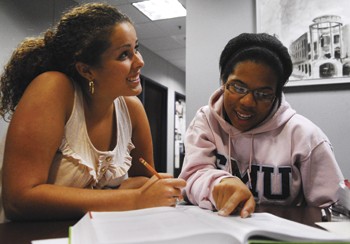 Taylor Lopez (left) gets pre-calculus help from Jessica Jones (right) yesterday evening in the Altshuler-Learning Enhancement Center.