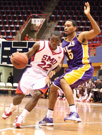 SMU guard Mike Walker maneuvers past a Paul Quinn defender at Moody Coliseum on Tuesday night