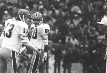 Pitt quarterback Dan Marino (13) argues the spot of a ball with the referee while Julius Dawkins  (80) looks on.