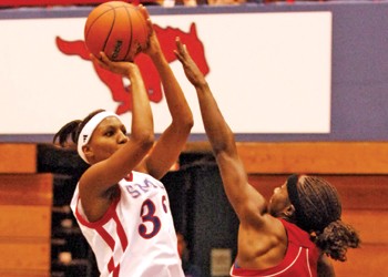 SMU guard Sharee Shepherd (left) takes a shot past the block of Houston's Brittani Allen (right) during last night's exhibition game at Moody.