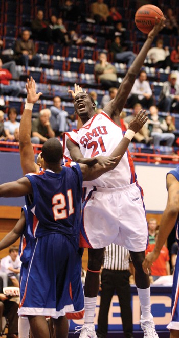 SMU center Bamba Fall makes a shot while covered by a Houston Baptist University defender at Moody Coliseum on Sunday afternoon.