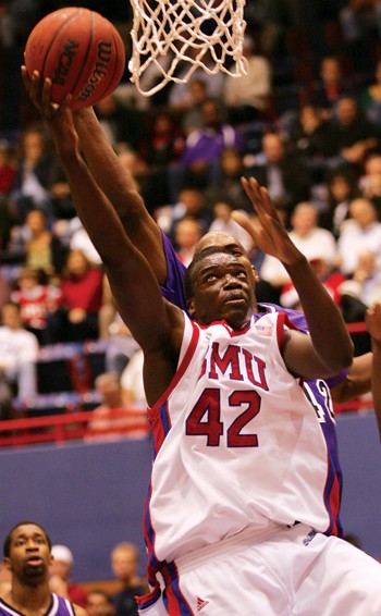 SMU forward Papa Dia (front) goes for the lay up past TCUs John Ortiz (back) during the second half of last nights game in Moody Coliseum.