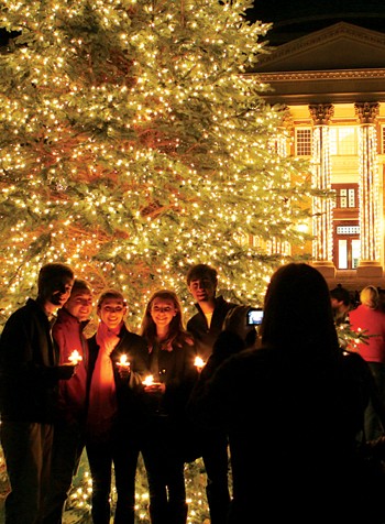 SMU students pose for a picture in front of the Christmas tree Sunday night after the Celebration of Lights ceremony held on the steps of Dallas Hall.