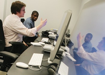 Digital Specialist Tyeson Seale (left) explains to first year Aaron Cheatham (right) how to use the new computers in the Norwick Center for Digital Services yesterday afternoon.  The center, which hosted an open house yesterday, offers students digital services ranging from video editing suites to PowerPoint software and group project rooms.