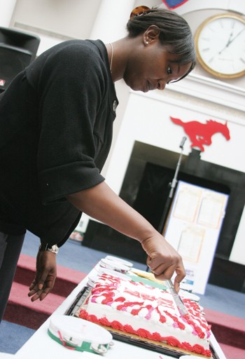 Keana Hardy, coordinator of Martin Luther King Jr. week, cuts a cake in the Hughes-Trigg Student Center yesterday afternoon during a birthday celebration for Martin Luther King, Jr.
