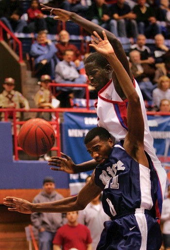 SMU center Bamba Fall (back) swats the ball away from Rice forward Patrick Britton (front) during the second half of Saturdays game at Moody Coliseum.