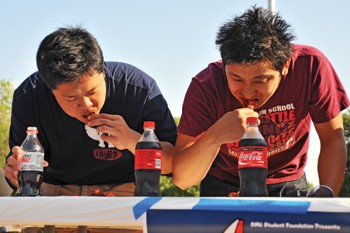 SMU students take part in a wing eating contest on the Mane Event stage Friday afternoon in front of Dallas Hall. Pluckers provided the wings.