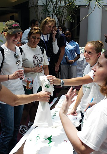 Students line up to exchange recyclable items for a free T-shirt displaying a green Pony Up logo during the Earth Day Celebration yesterday afternoon in the Hughes-Trigg Commons.