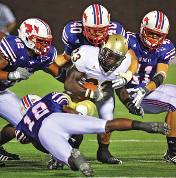 SMU defenders Derrius Bell (12), Anthony Sowe (42), Justin Smart (40), and Tyler Jones (41) combine to stop a Texas State Cougar on September 6, 2008.