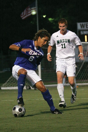 SMU forward Manuel Mariel looks to turn a cross into a goal as George Mason defender Michael Vallie rushes toward him in Fridays 3-0 win.
