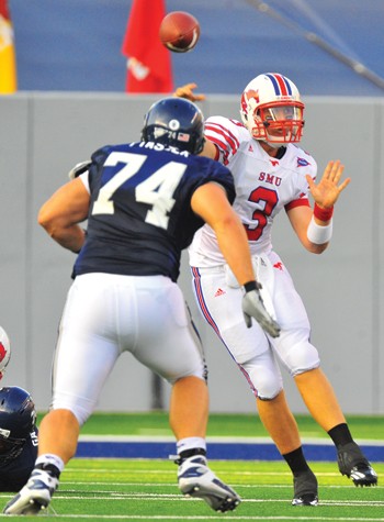 SMU quarterback Bo Levi Mitchell throws under pressure from Rice defensive lineman Chris Plaszek. In his first collegiate game, Mitchell completed 25 of 43 passes for 244 yards.