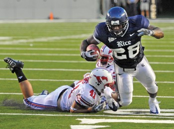 Rice running back C.J. Ugokowe breaks the tackle of SMU defensive back Tyler Jones in Friday nights 56-27 loss at Rice Stadium. After the Mustangs scored the first 13 points of the game, Rice responded with 28 unanswered points. For more pictures of the game, visit www.smudailycampus.com.