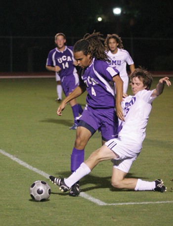 SMU midfielder Jeff Harwell slides to keep the ball away from University of Central Arkansas defender Andrew OBrien in a 5-1 win Oct. 12 at Westcott Field.