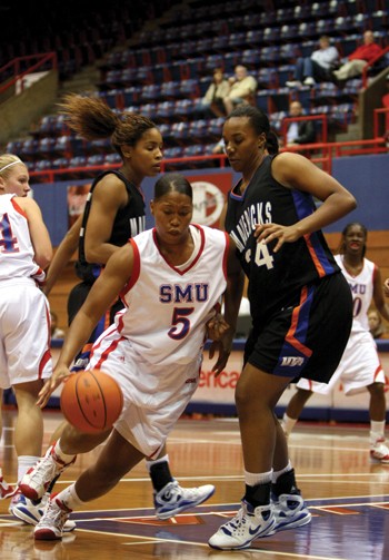 SMU forward Delisha Wills (5) drives to the basket around University of Texas at Arlingtons Candice Champion in the Lady Mustangs first conference game at Moody Coliseum. The team lost to UTA 85-79 Friday night.