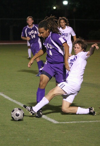 SMU senior Jeff Harwell (right) slide tackles University of Central Arkansas defender Andrew OBrien in a 5-1 win at Westcott Field Oct.12. Harwell was one of four Mustangs named second-team all-conference yesterday.
