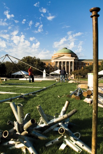 Workers from Ducky Bobs assemble a tent on the lawn of Dallas Hall Wednesday afternoon in preparation for Saturdays Homecoming game.