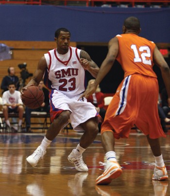 Paul McCoy (23) dribbles around Houston Baptist defender on Nov. 21. McCoy led the Mustangs with 15 points on Friday as SMU beat Texas A&M International 92-52 at Moody Coliseum.