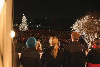 SMUs Christmas tree is surrounded by people during the Universitys annual Celebration of Lights Sunday night. The ceremony is candlelit until the first verse of Silent Night when lights come on in the quad.