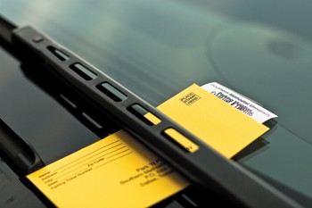 A Park N Pony parking violation sits under a windshield wiper outside of Fondren Library Thursday evening.