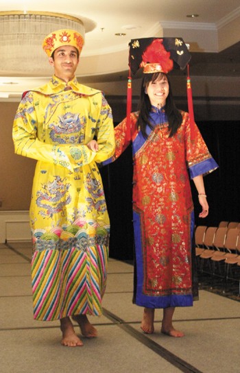 Two students model traditional Asian clothing  during the Asian Club's end of year fashion show in the Hughes- Trigg Ballroom.