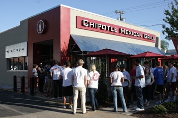 SMU students, faculty and staff wait for free food at the Chipotle Mexican Grill at McKinney and Armstrong Avenues Tuesday evening. Chipotle gave away free burritos and burrito bowls  as a thank you to the SMU community.